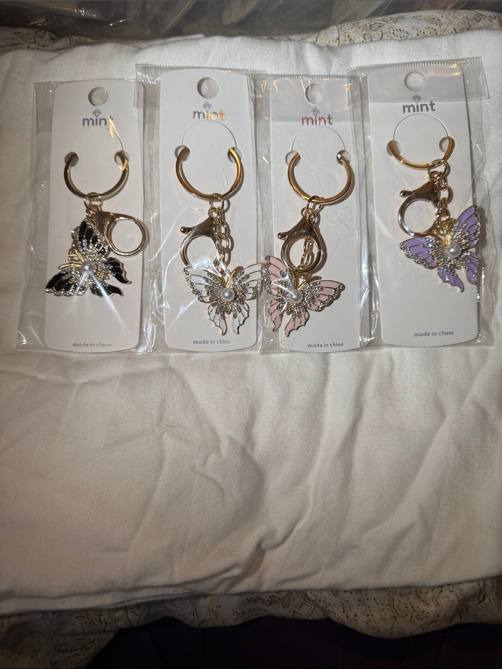 Rhinestone butterfly keychain/purse charm comes in purple, white, pink and black